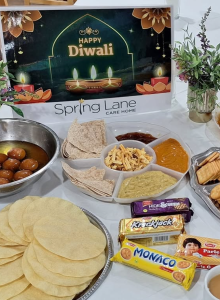 Diwali snacks at Spring Lane Care Home including poppadoms, Bombay mix, chutneys, gulab jamun and biscuits.