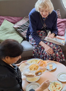 Residents at Spring Lane Care Home enjoying Diwali snacks, chatting and celebrating together.