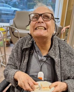 Residents holding plates of sandwiches at Spring Lane Care Home in Muswell Hill.