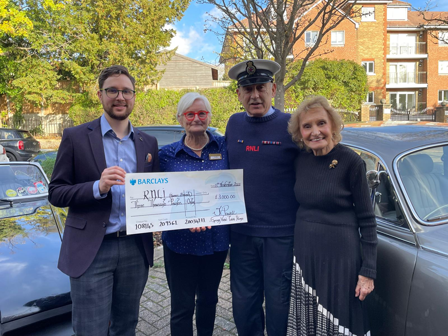 Springdene Care Homes residents and community members presenting a charity cheque at a local fundraising event