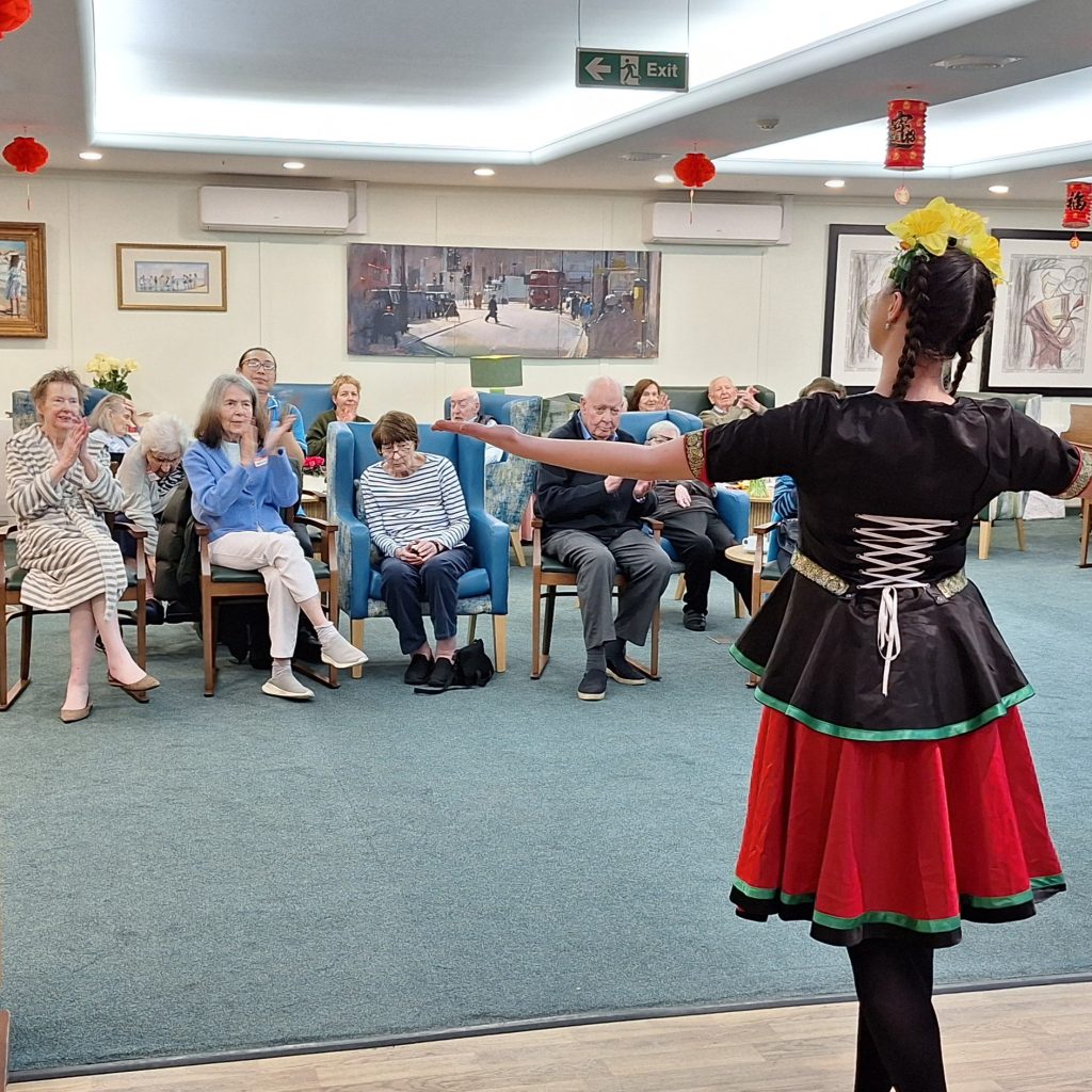 Residents watching Welsh dancing performance during St David’s Day celebration at Springdene Care Home.