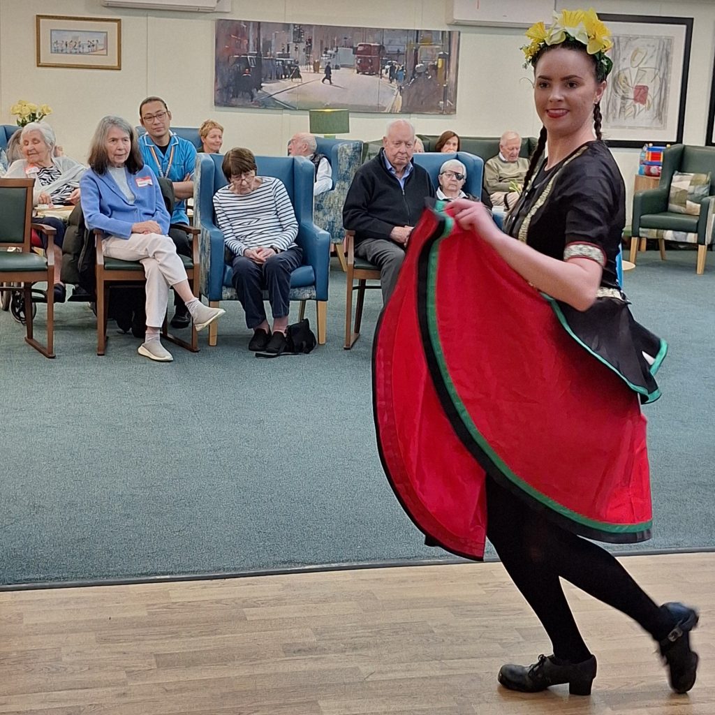 Traditional Welsh dancer performing for residents during St David’s Day celebration at Springdene Care Homes in North London.