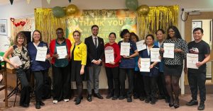 Staff at Spring Lane Care Home celebrating Employee Appreciation Day in North London with awards and decorations