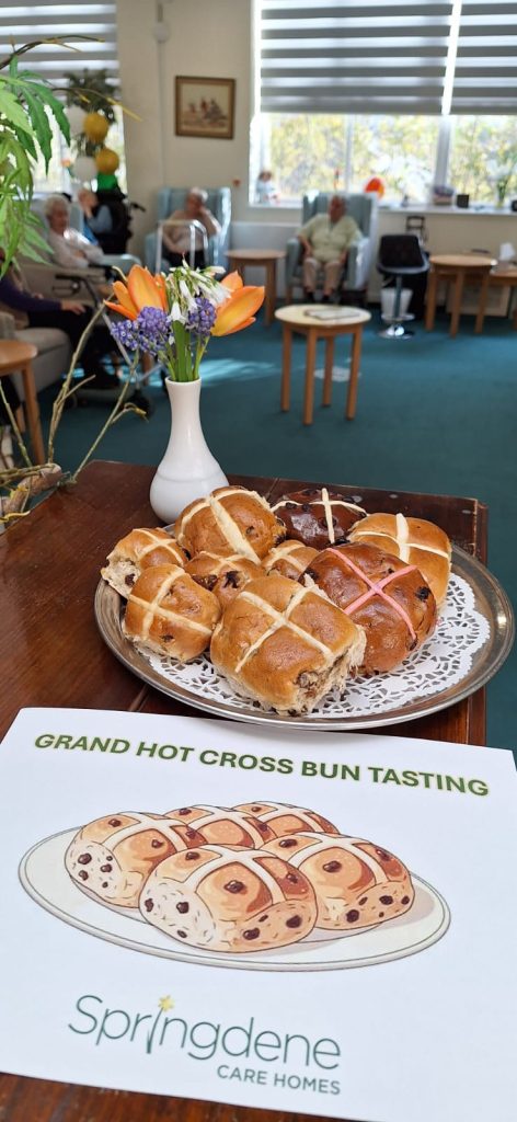 Residents enjoying a hot cross bun tasting activity at Springdene Care Home during Easter celebrations in North London