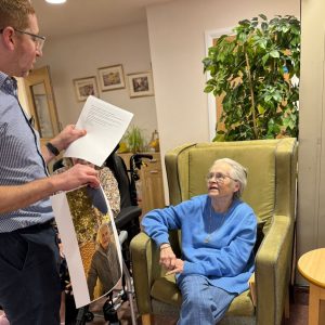 Resident listening during a reminiscence session about women in science at Spring Lane Care Home Muswell Hill