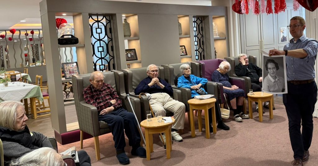 Residents participating in a cognitive wellbeing activity focused on women in science in North London care home