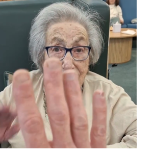 Resident enjoying a National High Five Day interaction at Spring Grove Care Home.