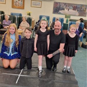Young Irish dancer entertaining residents during St Patrick's Day festivities.