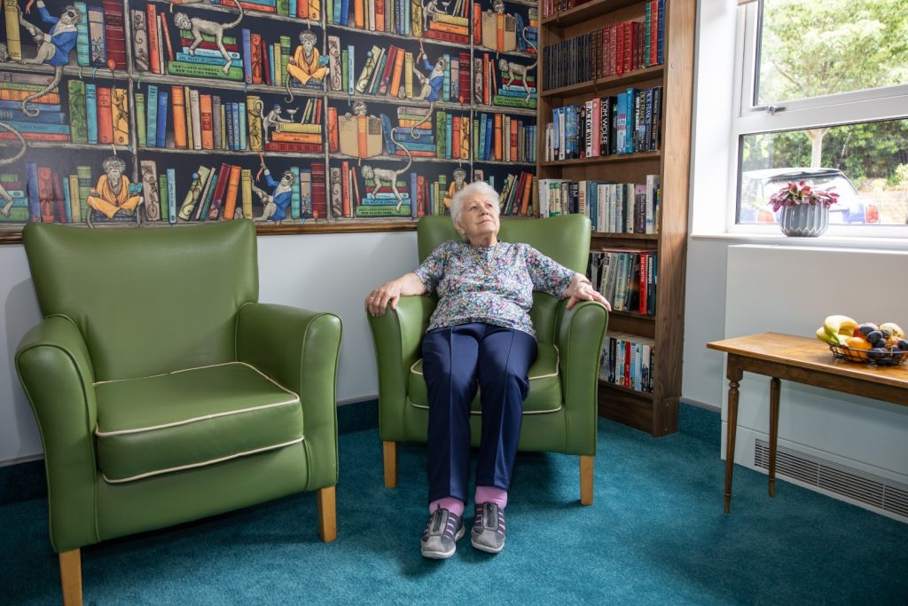 Resident enjoying conversation in the comfortable lounge at Springview Care Home in Enfield