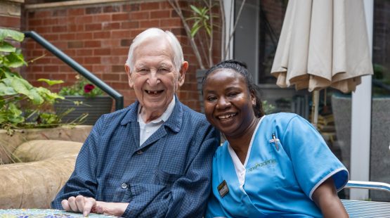 Resident and care team member enjoying time together in the garden at Spring Grove Care Home.