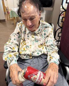 Resident sampling Cruzcampo during Beer Day Britain at Springdene Care Homes