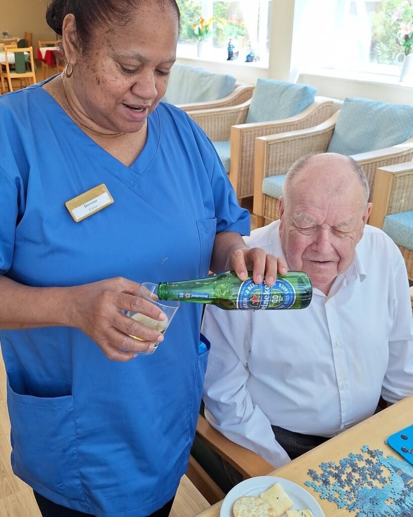 Carer and resident enjoying a World Cup themed activity at Springdene Care Homes