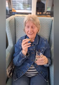 Springdene Care Homes resident smiling with a glass and lime during National Tequila Day celebrations.